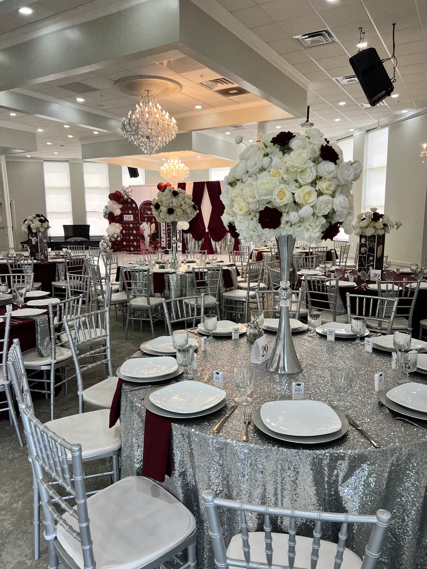 Elegant burgundy and silver ballroom reception design by Lavish Events by Talia